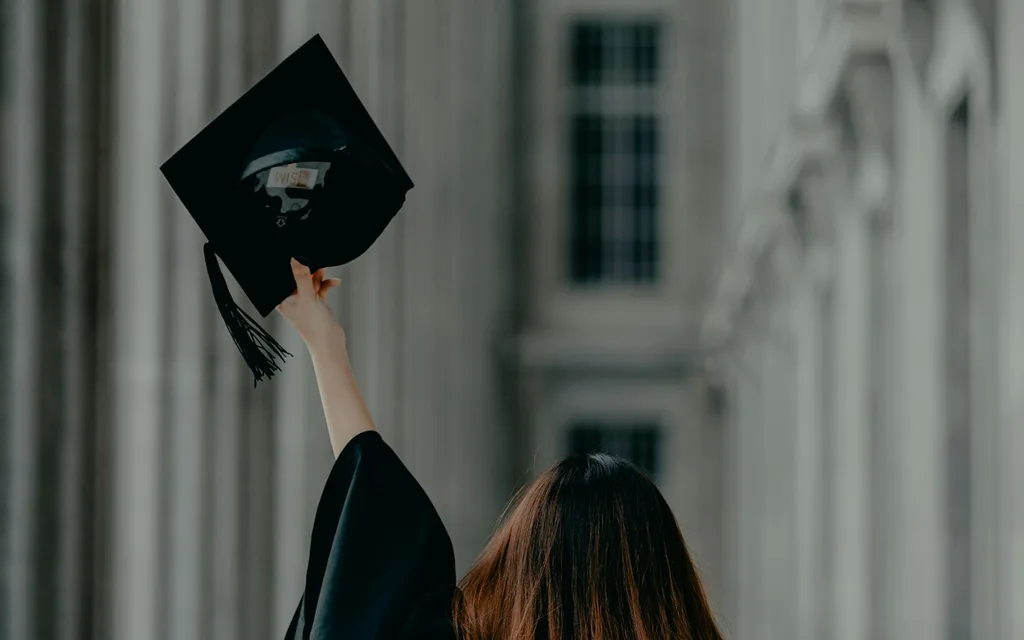 a woman in a graduation cap and gown